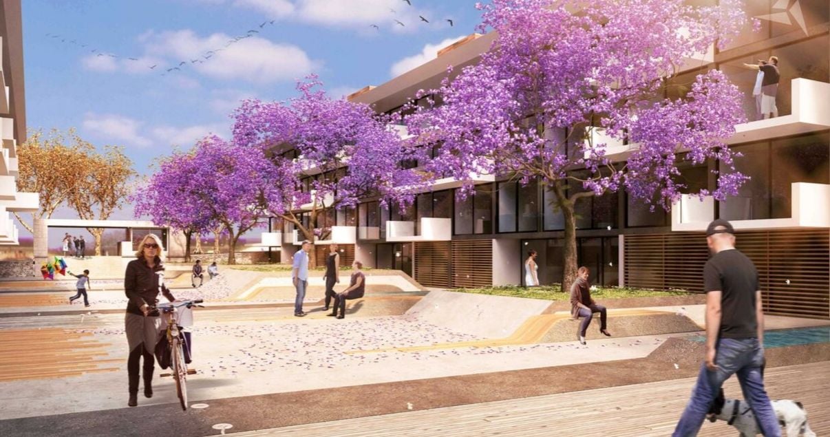 Exterior del edificio Molino del Parque con flores violetas y gente de Lamorte _ Asociados