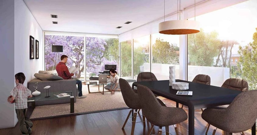 Interior de un apartamento con una familia y una mesa con sillas en el edificio Molino del Parque de Lamorte _ Asociados